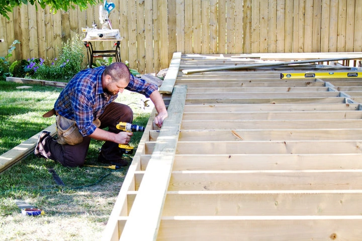 Professional crew installing a custom backyard deck in a Sacramento residential property